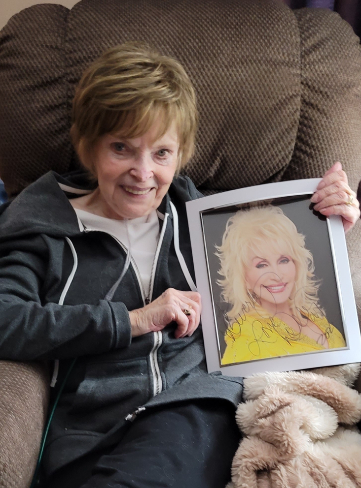 Beverly with signed photo of Dolly Parton