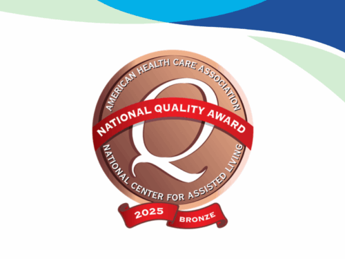 Certainly! Here’s an improved description for your badge design, meeting all your requests: A bronze 2025 National Quality Award badge from the American Health Care Association and National Center for Assisted Living on a white background with blue and green curved accents, featuring the brand name Care Initiative.